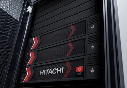 Technician working in a server room with Hitachi servers.